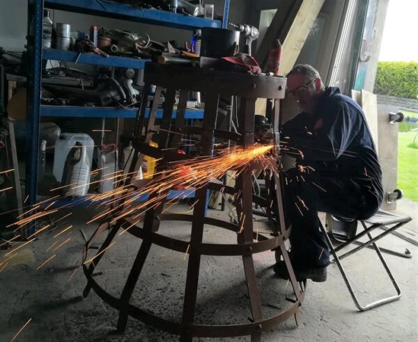 Man working on metal with sparks flowing